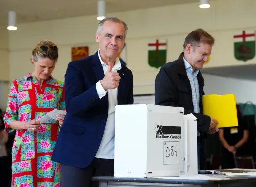 Canadian Prime Minister and Liberal leader Mark Carney, alongside his wife Diana Fox Carney (L), gives a thumbs up after casting his ballot a polling station during the federal election in Ottawa, Canada on April 28, 2025